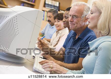 Five people at computer terminals in library (depth of field) View Large Photo Image Picture - Five people at computer terminals in library (depth of field). Fotosearch