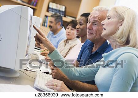 Five people at computer terminals in library (depth of field) View Large Photo Image Stock Photo - Five people at computer terminals in library (depth of field). Fotosearch