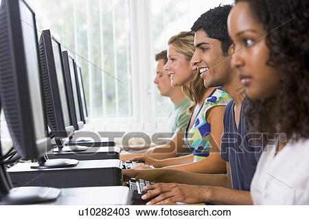 Four people sitting at computer terminals (selective focus/high key) View Large Photo Image Stock Image - Four people sitting at computer terminals (selective focus/high key). Fotosearch