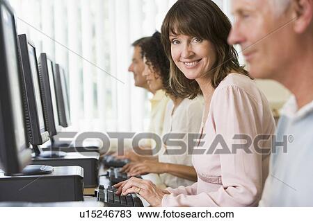 Four people sitting at computer terminals (selective focus/high key) View Large Photo Image Stock Image - Four people sitting at computer terminals (selective focus/high key). Fotosearch