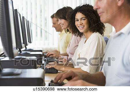 Four people sitting at computer terminals (selective focus/high key) View Large Photo Image Stock Photo - Four people sitting at computer terminals (selective focus/high key). Fotosearch
