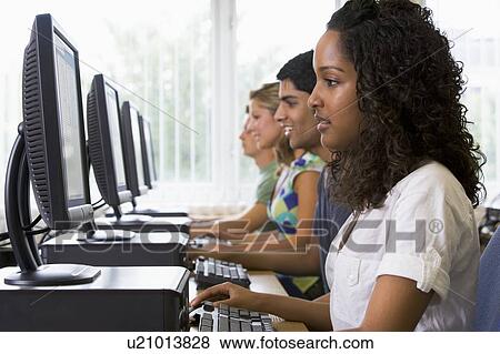 Four people sitting at computer terminals (depth of field/high key) View Large Photo Image Stock Photo - Four people sitting at computer terminals (depth of field/high key). Fotosearch