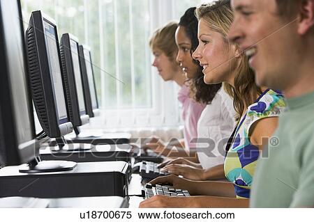 Four people sitting at computer terminals (selective focus) View Large Photo Image Stock Photography - Four people sitting at computer terminals (selective focus). Fotosearch
