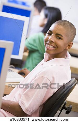 Stock Image - Male student in computer class. Fotosearch