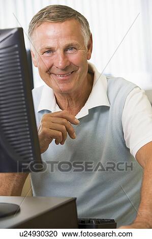 Man sitting at a computer terminal (high key) View Large Photo Image Stock Image - Man sitting at a computer terminal (high key). Fotosearch