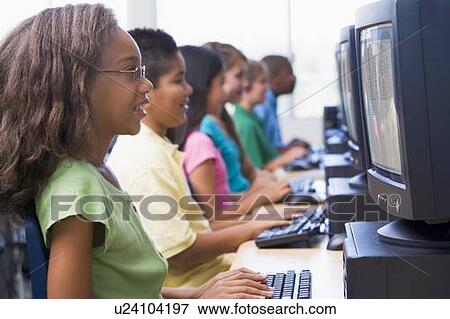 Stock Photo - Six children at computer terminals (depth of field/high key). Fotosearch