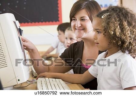 Students in class at computer terminals with teacher (selective focus) View Large Photo Image Stock Image - Students in class at computer terminals with teacher (selective focus). Fotosearch