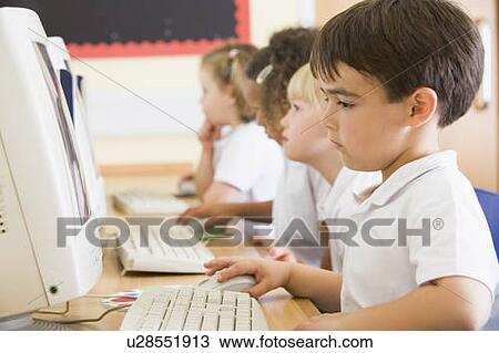 Stock Image - Students in class at computer terminals (depth of field). Fotosearch