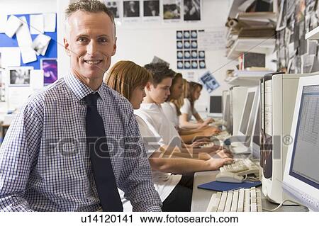 Students working on computer workstations with teacher View Large Photo Image Stock Image - Students working on computer workstations with teacher. Fotosearch