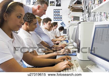 Students working on computer workstations with teacher View Large Photo Image Stock Photography - Students working on computer workstations with teacher. Fotosearch