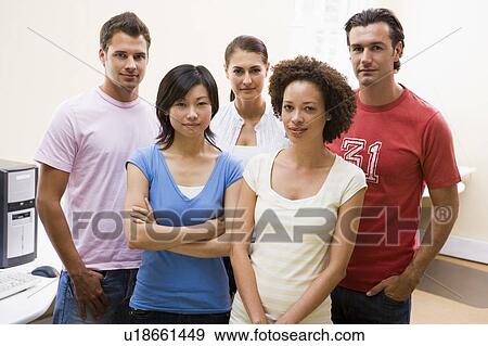 Stock Photo - Five people standing in computer room. Fotosearch