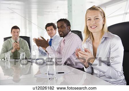 Four businesspeople in a boardroom applauding View Large Photo Image Stock Image - Four businesspeople in a boardroom applauding. Fotosearch