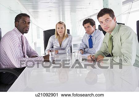 Four businesspeople in a boardroom View Large Photo Image Stock Image - Four businesspeople in a boardroom. Fotosearch