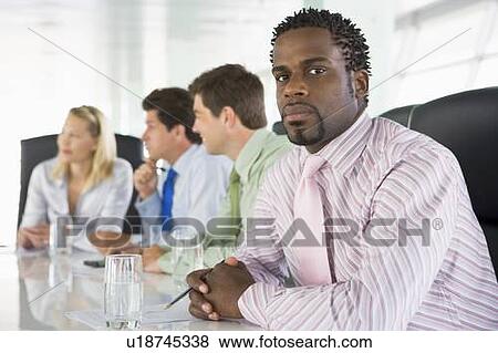 Four businesspeople in a boardroom View Large Photo Image Stock Photo - Four businesspeople in a boardroom. Fotosearch