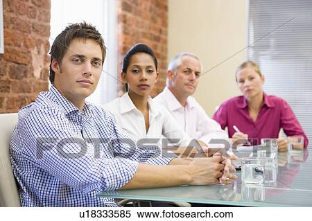 Stock Photography - Four businesspeople in boardroom. Fotosearch