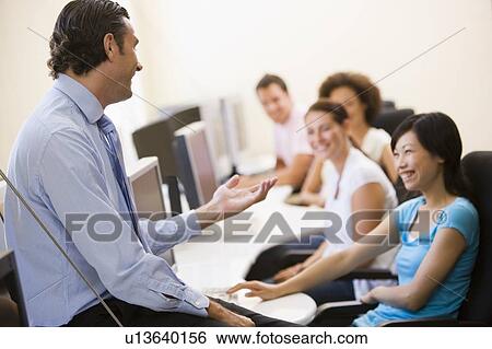 Man giving lecture in computer class View Large Photo Image Stock Photograph - Man giving lecture in computer class. Fotosearch
