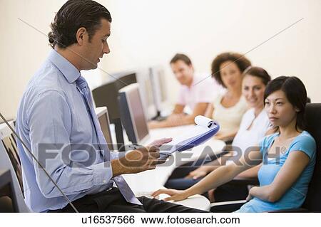 Man with clipboard giving lecture in computer class View Large Photo Image Stock Photograph - Man with clipboard giving lecture in computer class. Fotosearch