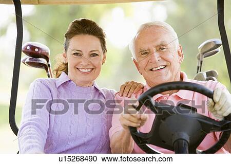 Stock Image - Couple Enjoying A Game Of Golf. Fotosearch