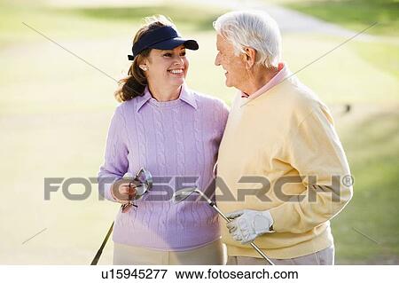 Stock Photo - Couple Enjoying A Game Of Golf. Fotosearch