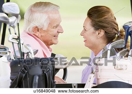 Couple Enjoying A Game Of Golf View Large Photo Image Stock Photo - Couple Enjoying A Game Of Golf. Fotosearch