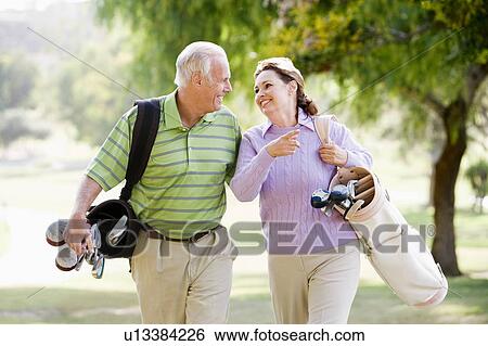 Couple Enjoying A Game Of Golf View Large Photo Image Stock Photograph - Couple Enjoying A Game Of Golf. Fotosearch