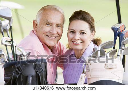 Couple Enjoying A Game Of Golf View Large Photo Image Stock Photograph - Couple Enjoying A Game Of Golf. Fotosearch