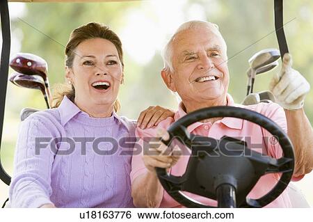 Stock Photograph - Couple Enjoying A Game Of Golf. Fotosearch
