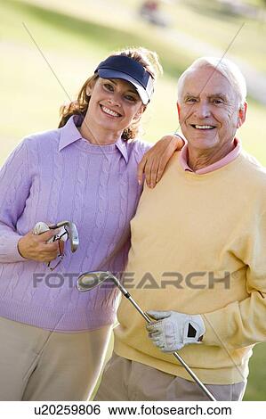 Stock Photograph - Couple Enjoying A Game Of Golf. Fotosearch