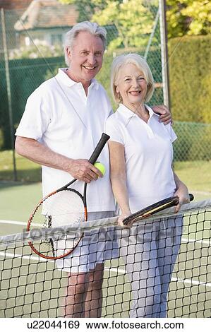 Couple playing tennis and smiling View Large Photo Image Stock Photo - Couple playing tennis and smiling. Fotosearch