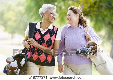 Female Friends Enjoying A Game Of Golf View Large Photo Image Stock Image - Female Friends Enjoying A Game Of Golf. Fotosearch