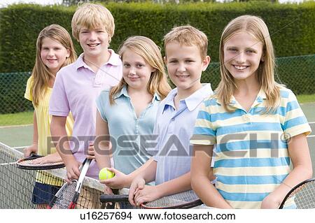 Five young friends with rackets on tennis court smiling View Large Photo Image Picture - Five young friends with rackets on tennis court smiling. Fotosearch