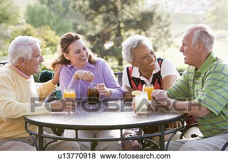 Stock Photo - Friends Enjoying A Beverage By A Golf Course. Fotosearch