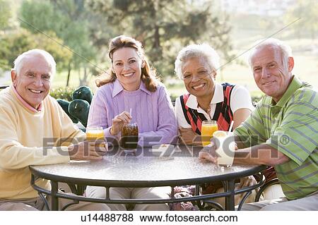 Friends Enjoying A Beverage By A Golf Course View Large Photo Image Stock Photo - Friends Enjoying A Beverage By A Golf Course. Fotosearch