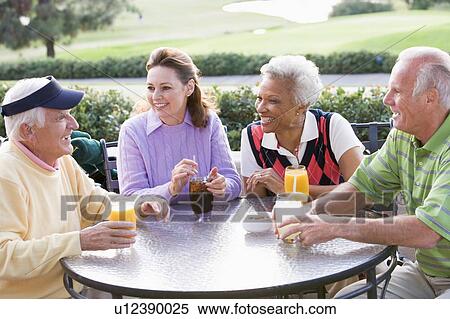 Stock Photography - Friends Enjoying A Beverage By A Golf Course. Fotosearch