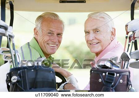 Stock Image - Male Friends Enjoying A Game Of Golf. Fotosearch