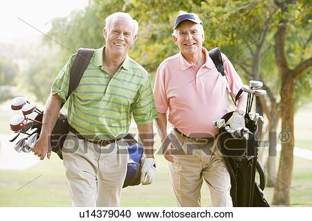 Stock Image - Male Friends Enjoying A Game Of Golf. Fotosearch