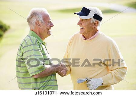 Stock Image - Male Friends Enjoying A Game Of Golf. Fotosearch
