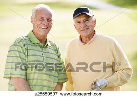 Male Friends Enjoying A Game Of Golf View Large Photo Image Stock Photo - Male Friends Enjoying A Game Of Golf. Fotosearch