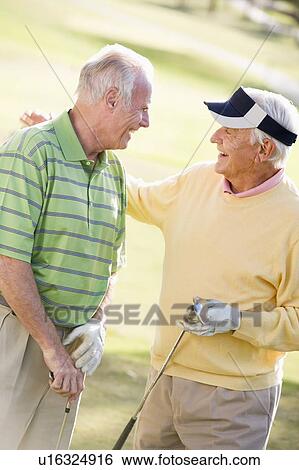 Stock Photograph - Male Friends Enjoying A Game Of Golf. Fotosearch