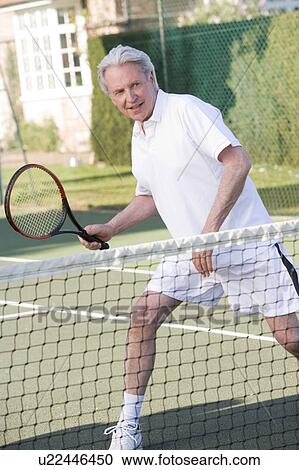 Man playing tennis and smiling View Large Photo Image Stock Image - Man playing tennis and smiling. Fotosearch