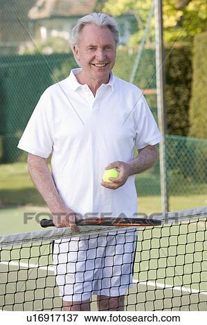 Man playing tennis and smiling View Large Photo Image Stock Photo - Man playing tennis and smiling. Fotosearch