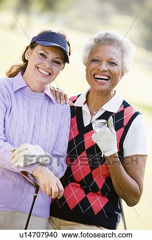 Stock Image - Portrait Of Two Female Golfers. Fotosearch