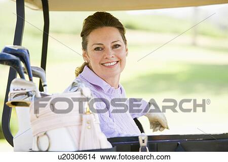 Picture - Portrait Of Woman Sitting In A Golf Cart. Fotosearch