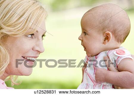 Mother and baby outdoors smiling View Large Photo Image Stock Image - Mother and baby outdoors smiling. Fotosearch