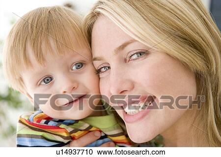 Mother and young boy indoors smiling View Large Photo Image Stock Image - Mother and young boy indoors smiling. Fotosearch