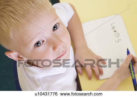 Stock Photograph - Student in class learning spelling (selective focus). Fotosearch