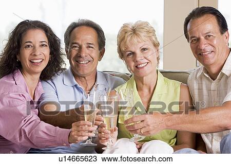 Two couples in living room drinking champagne and smiling View Large Photo Image Stock Image - Two couples in living room drinking champagne and smiling. Fotosearch