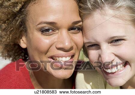 Two young women posing outdoors View Large Photo Image Stock Image - Two young women posing outdoors. Fotosearch