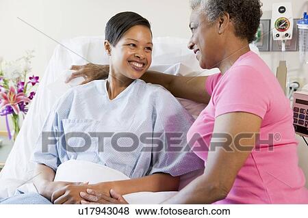 Stock Photo - Woman And Her Mother Talking In Hospital. Fotosearch