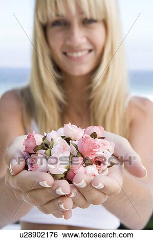 Woman holding a handful of roses View Large Photo Image Stock Photograph - Woman holding a handful of roses. Fotosearch